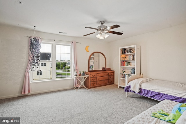 bedroom with baseboards, ceiling fan, visible vents, and carpet