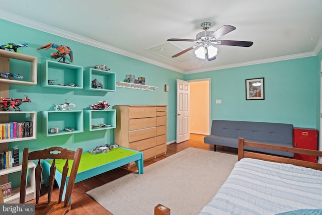 bedroom with a ceiling fan, ornamental molding, and wood finished floors