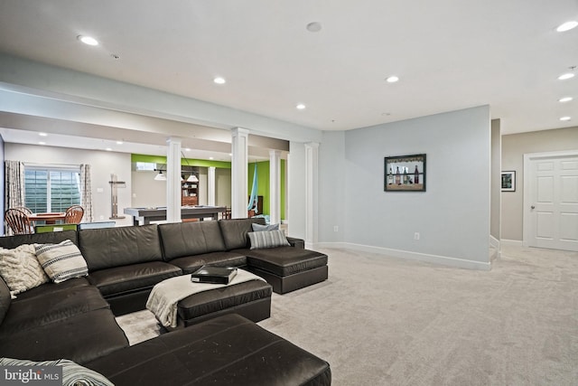 living area with baseboards, light carpet, recessed lighting, and ornate columns