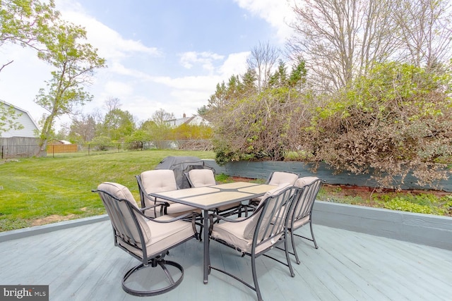 wooden deck with a fenced backyard, outdoor dining space, a yard, and a patio area