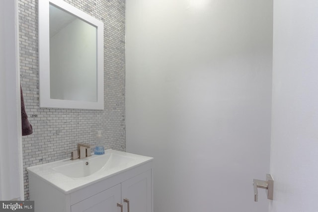 bathroom featuring vanity, decorative backsplash, and tile walls