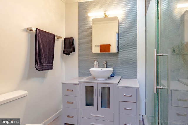 full bathroom with vanity, a stall shower, and toilet