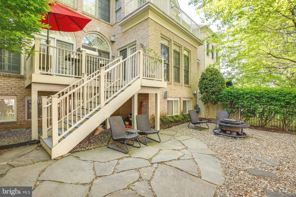 view of patio / terrace featuring stairway and a fire pit