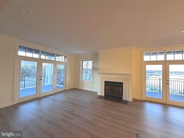 4250 Granby St Unit 105, Norfolk, VA 23504 - unfurnished living room with french doors, crown molding, dark wood-type flooring, baseboards, and a tile fireplace