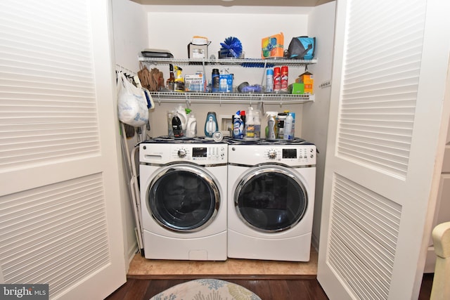 washroom with washing machine and dryer, laundry area, and wood finished floors