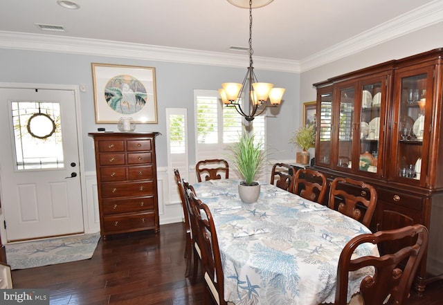 dining area featuring ornamental molding, dark wood finished floors, a chandelier, and visible vents