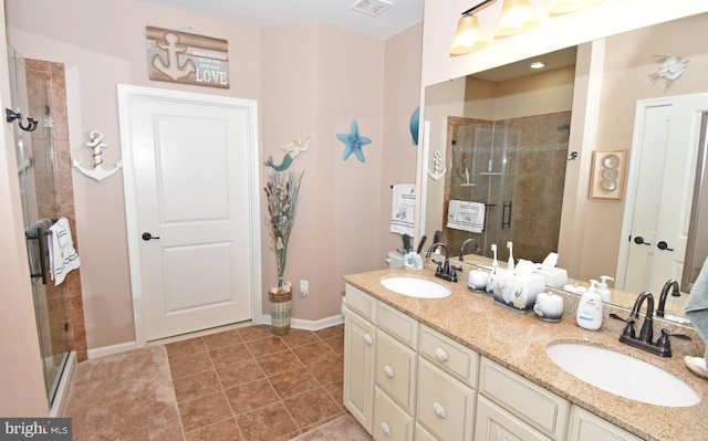 bathroom featuring baseboards, a shower stall, and a sink