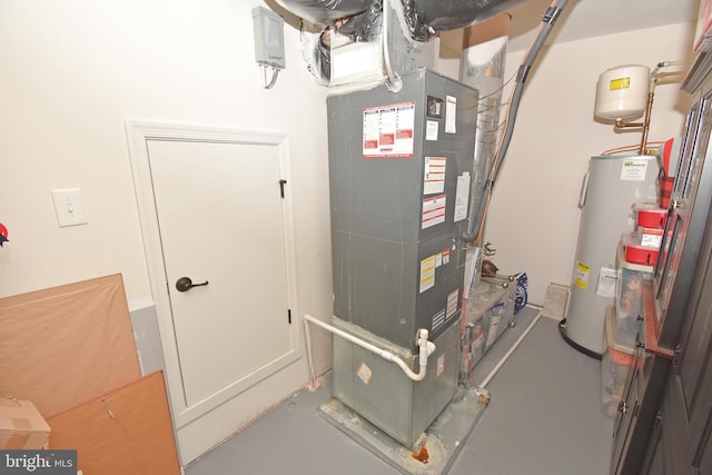 utility room with heating unit and water heater