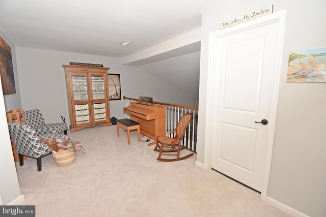 living area with carpet flooring, baseboards, and lofted ceiling