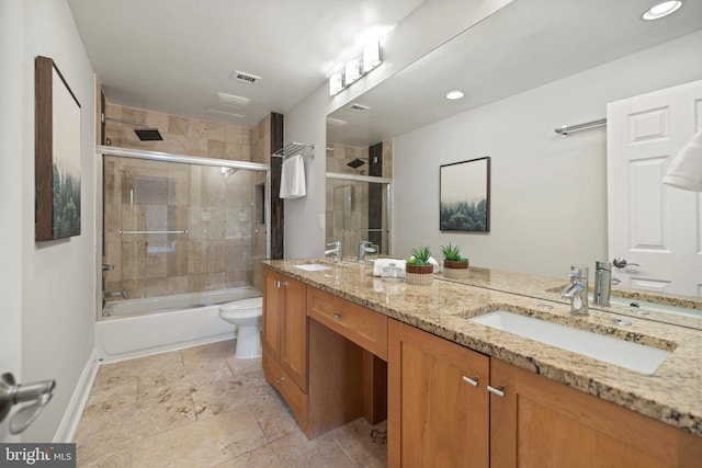 bathroom featuring visible vents, a sink, double vanity, and toilet
