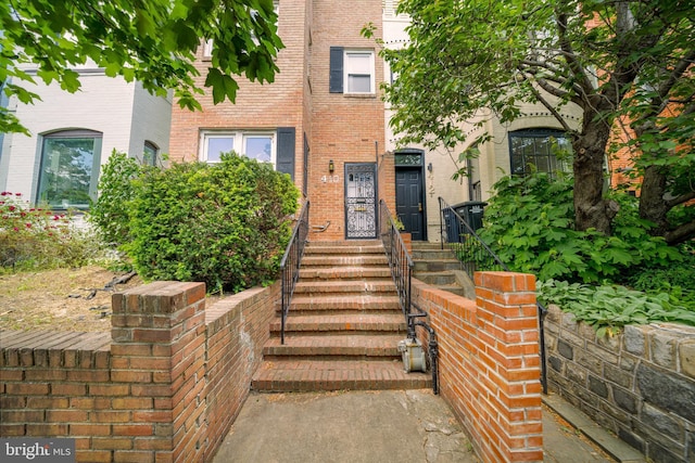 property entrance featuring brick siding