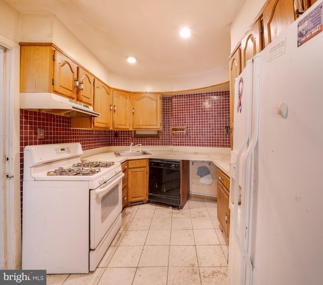 kitchen with white appliances, under cabinet range hood, a sink, light countertops, and backsplash