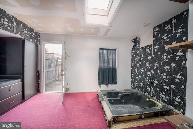 bathroom featuring wallpapered walls and a skylight