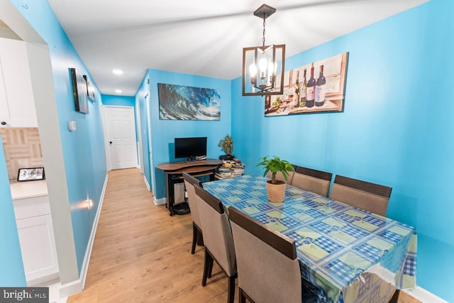 dining room with baseboards, recessed lighting, light wood-style flooring, and a notable chandelier