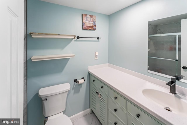 full bath with vanity, marble finish floor, toilet, baseboards, and an enclosed shower