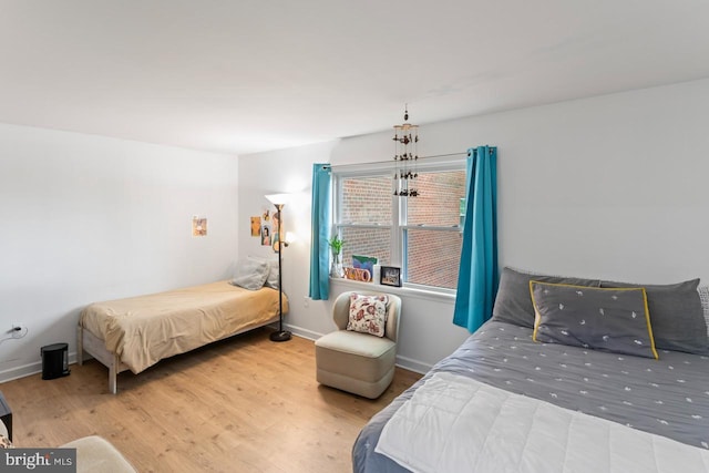 bedroom with baseboards and wood finished floors