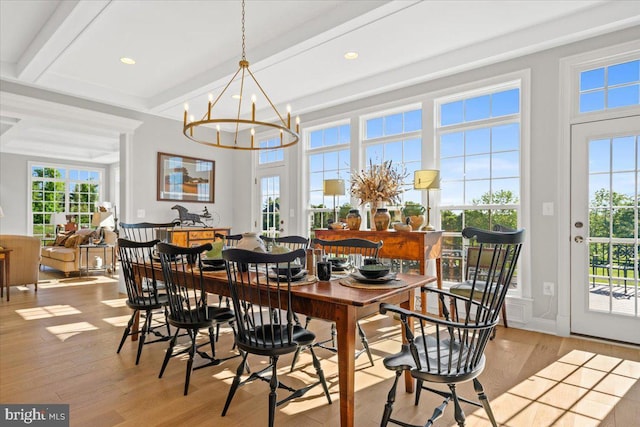 dining space featuring recessed lighting, beamed ceiling, an inviting chandelier, and light wood-style flooring