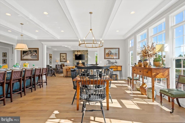 dining room featuring a chandelier, light wood-style flooring, recessed lighting, baseboards, and beamed ceiling