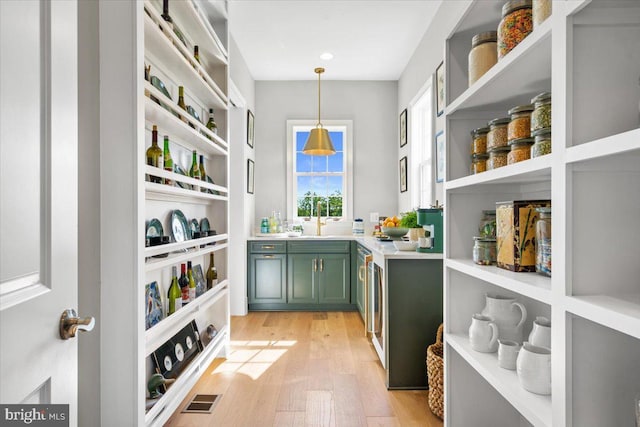 storage area with a sink and wine cooler