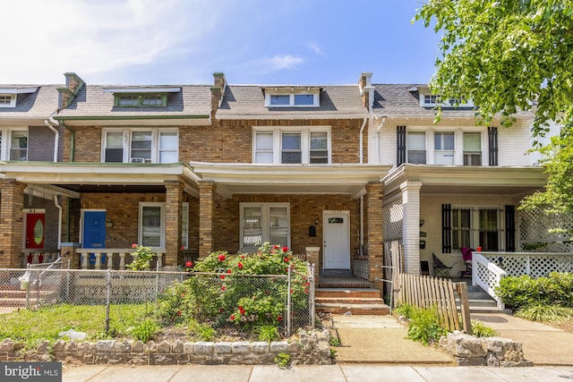 1222 18th St NE, Washington, DC 20002 - townhome / multi-family property featuring a porch, fence private yard, mansard roof, and brick siding