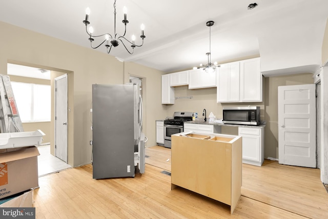 1222 18th St NE, Washington, DC 20002 - kitchen with stainless steel appliances, a chandelier, white cabinetry, and light wood-style floors