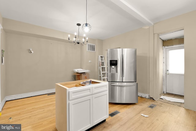 1222 18th St NE, Washington, DC 20002 - kitchen featuring white cabinets, visible vents, stainless steel fridge with ice dispenser, and light wood-style floors