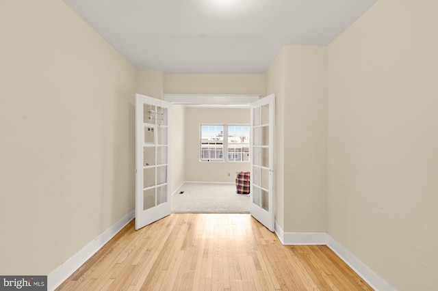 1222 18th St NE, Washington, DC 20002 - hallway with french doors, light wood-style flooring, and baseboards