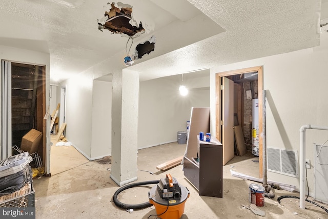 1222 18th St NE, Washington, DC 20002 - interior space featuring a textured ceiling and gas water heater