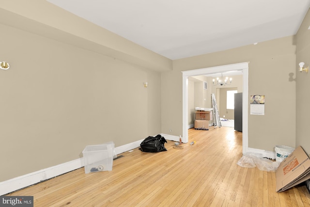 1222 18th St NE, Washington, DC 20002 - unfurnished room featuring an inviting chandelier, baseboards, and wood-type flooring