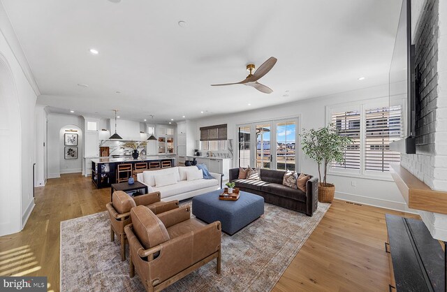 76 Filly Ln, Lewes, DE 19958 - living room featuring ceiling fan, baseboards, recessed lighting, arched walkways, and light wood finished floors
