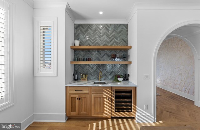 76 Filly Ln, Lewes, DE 19958 - indoor wet bar with beverage cooler, ornamental molding, baseboards, and decorative backsplash