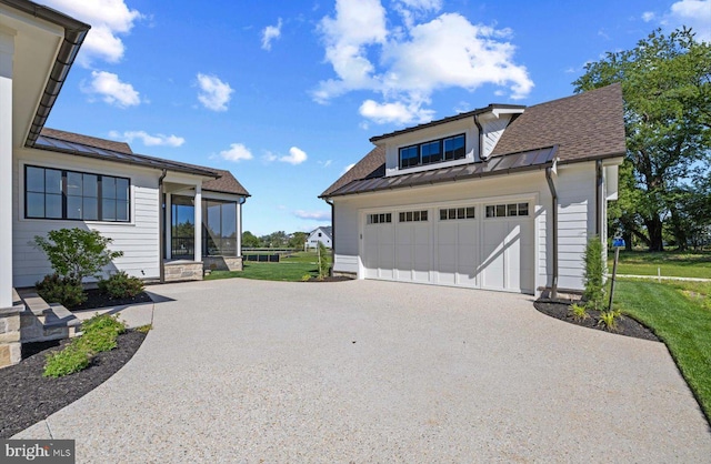 76 Filly Ln, Lewes, DE 19958 - view of front of home with a garage, driveway, a standing seam roof, metal roof, and a front yard
