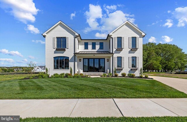 76 Filly Ln, Lewes, DE 19958 - view of front of house featuring a standing seam roof, a front lawn, and metal roof