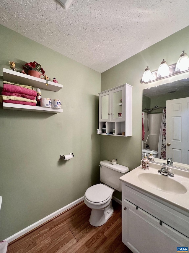 full bathroom with vanity, wood finished floors, toilet, baseboards, and a shower with curtain