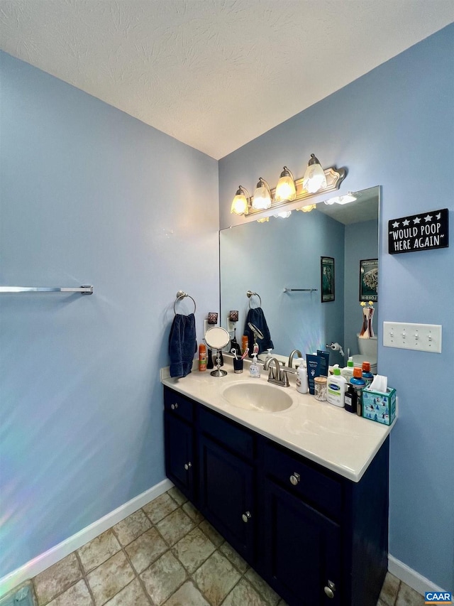 bathroom featuring baseboards and vanity