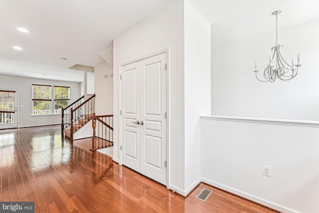 8210 Heritage Crossing Ct, Manassas, VA 20109 - hallway featuring hardwood / wood-style flooring, a chandelier, stairway, baseboards, and recessed lighting