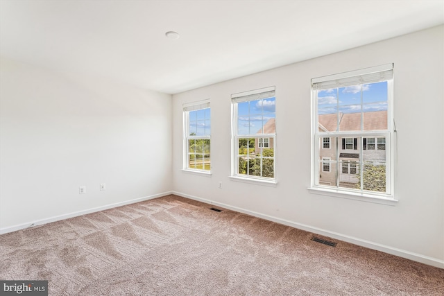 8210 Heritage Crossing Ct, Manassas, VA 20109 - empty room featuring baseboards, carpet flooring, and plenty of natural light