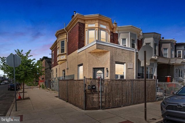 view of property featuring a fenced front yard and cooling unit