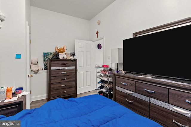 bedroom featuring baseboards and wood finished floors