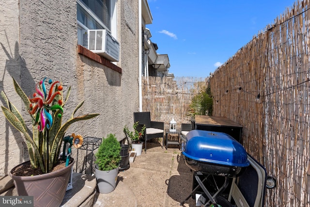 view of patio featuring a fenced backyard and a grill