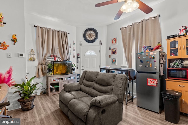 living room with a ceiling fan and wood finished floors
