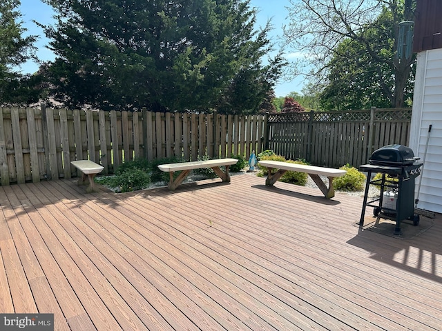 wooden deck with fence and area for grilling