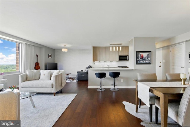 9701 Fields Rd Unit 2301, Gaithersburg, MD 20878 - living room featuring dark wood-style flooring and baseboards