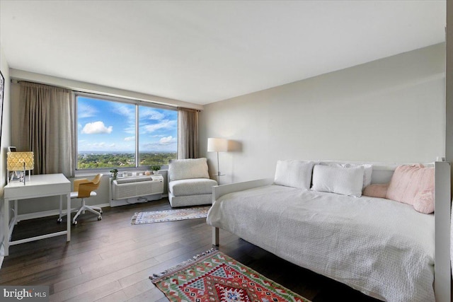 9701 Fields Rd Unit 2301, Gaithersburg, MD 20878 - bedroom with hardwood / wood-style flooring, baseboards, and a wall unit AC