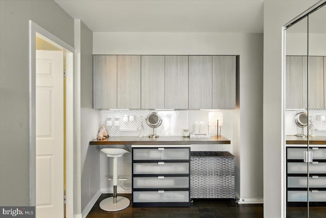 9701 Fields Rd Unit 2301, Gaithersburg, MD 20878 - bar with decorative backsplash, dark wood-type flooring, and baseboards