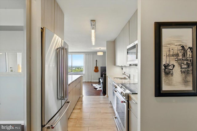 9701 Fields Rd Unit 2301, Gaithersburg, MD 20878 - kitchen featuring premium appliances, modern cabinets, light countertops, and a sink
