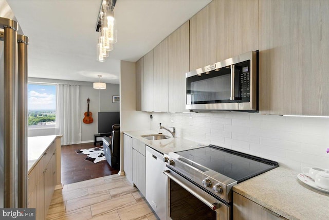 9701 Fields Rd Unit 2301, Gaithersburg, MD 20878 - kitchen with stainless steel appliances, a sink, tasteful backsplash, modern cabinets, and hanging light fixtures