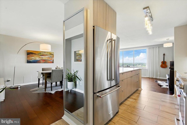 9701 Fields Rd Unit 2301, Gaithersburg, MD 20878 - kitchen featuring appliances with stainless steel finishes, modern cabinets, light brown cabinets, light wood-style floors, and light countertops
