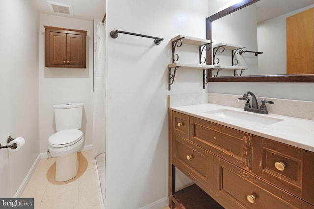 bathroom featuring visible vents, vanity, toilet, baseboards, and tile patterned floors