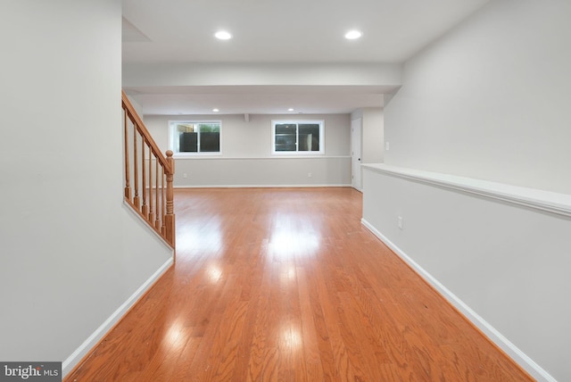 hall featuring recessed lighting, stairway, baseboards, and light wood finished floors